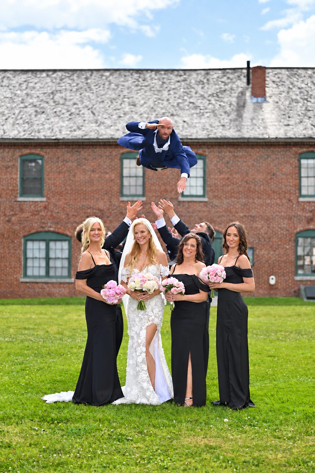 Bridesmaids tossing the groom into the air